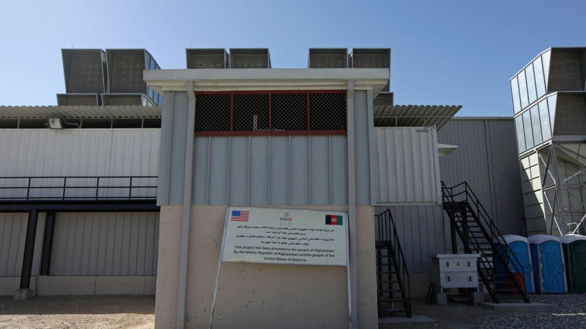A sign reads that the power plant is built with the help of USAID, at the Tarakhil power plant in the outskirts of Kabul.