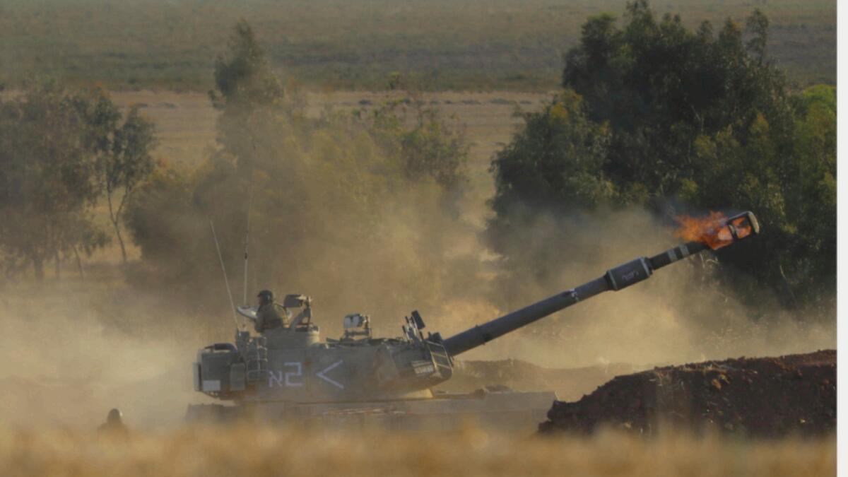 An Israeli artillery unit fires toward targets in Gaza Strip, at the Israeli Gaza border. — AP