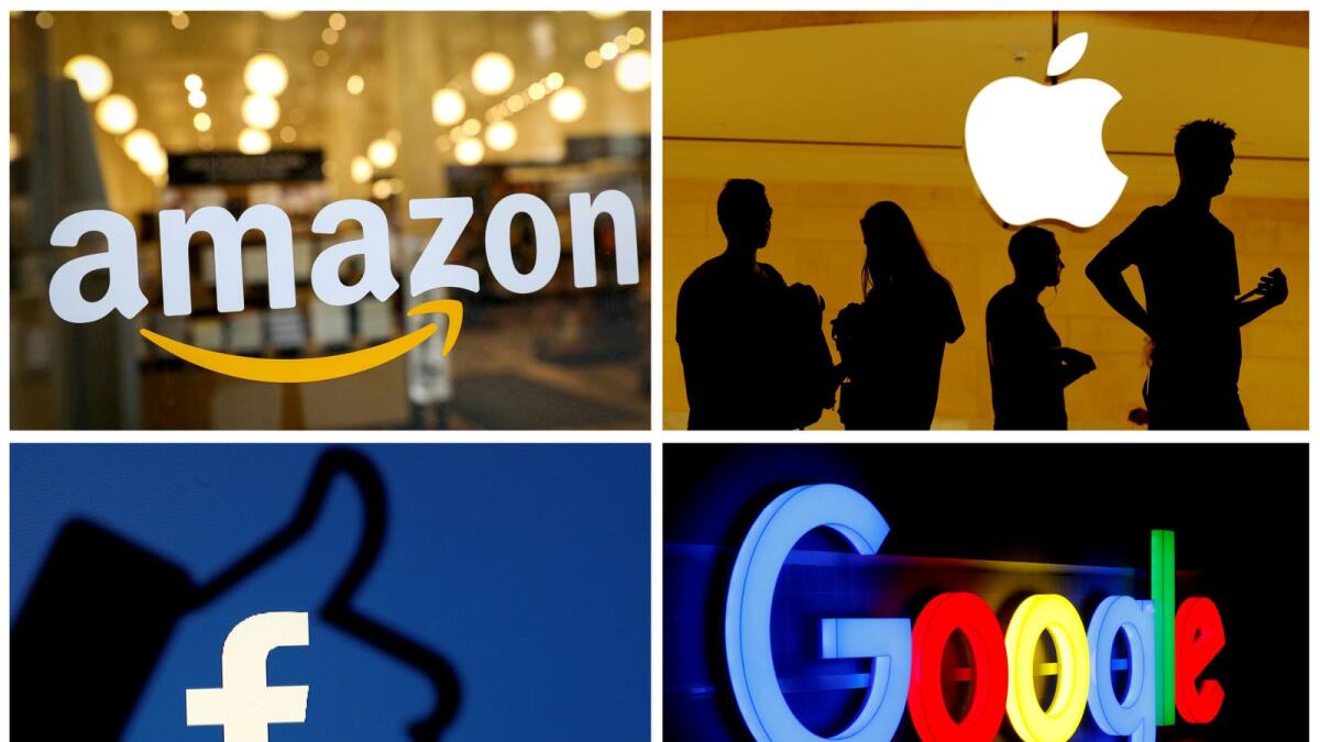 The logos of Amazon, Apple, Facebook and Google in a combination photo.