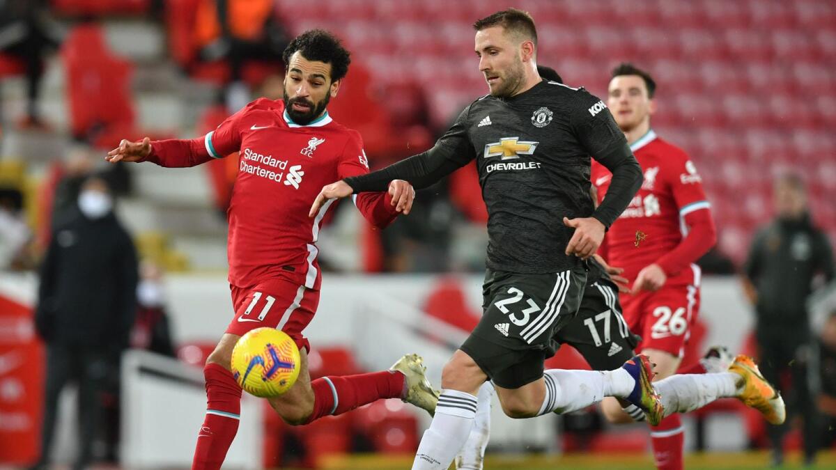 Liverpool's Mohamed Salah (left) vies for the ball with Manchester United's Luke Shaw. — AFP