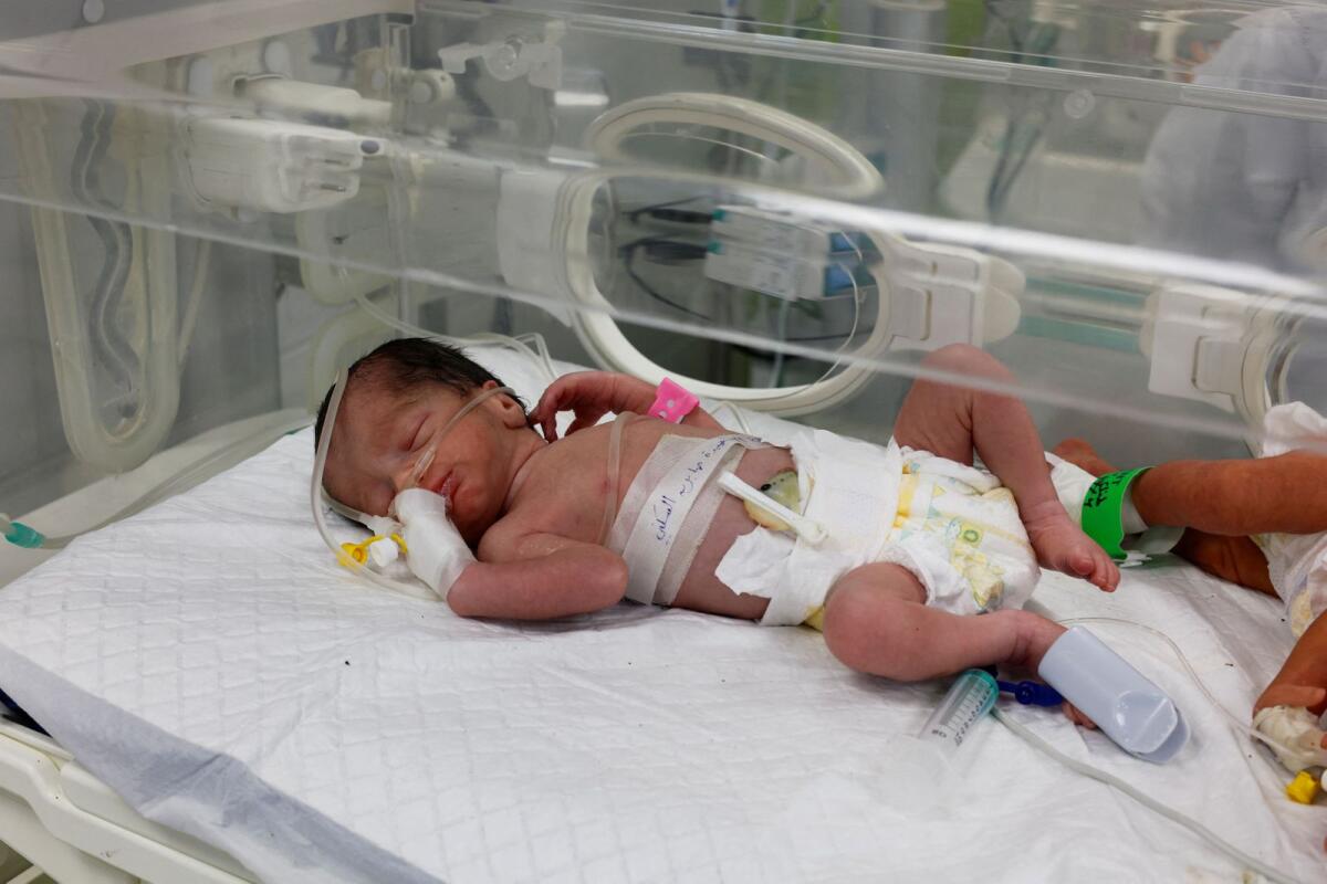 A Palestinian baby girl, saved from the womb of her mother Sabreen Al-Sheikh (Al-Sakani), who was killed in an Israeli strike along with her husband Shokri and her daughter Malak, lies in an incubator at Al Emirati hospital in Rafah in the southern Gaza Strip on Sunday.  — Reuters