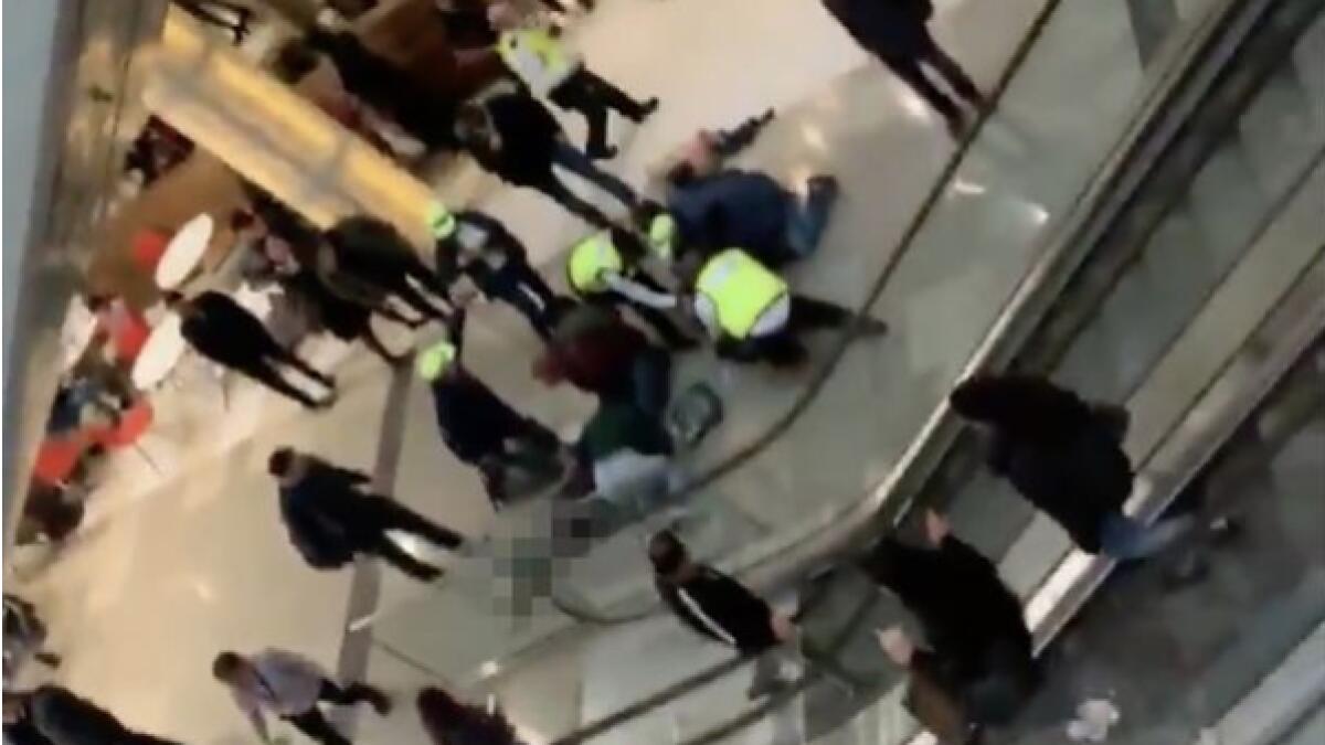 Man jumps two floors, lands on womans head in crowded mall