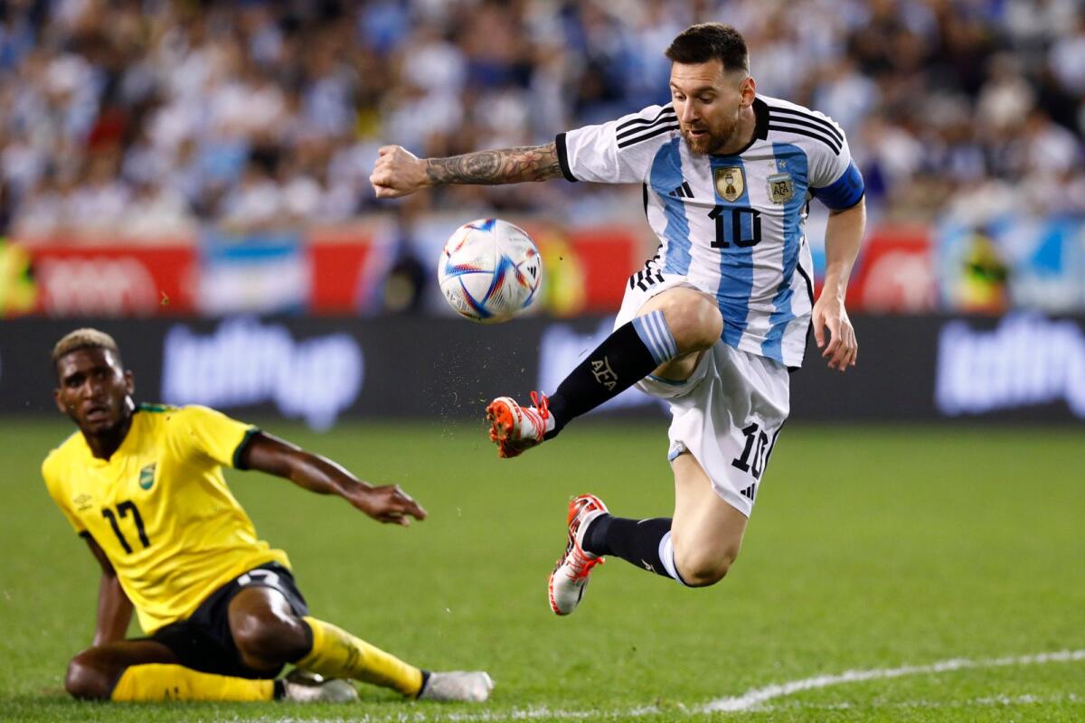 Argentina's Lionel Messi (right) dribbles past Jamaica's Damion Lowe during the team's 3-0 win in the international friendly at the Red Bull Arena in New Jersey. (AFP)
