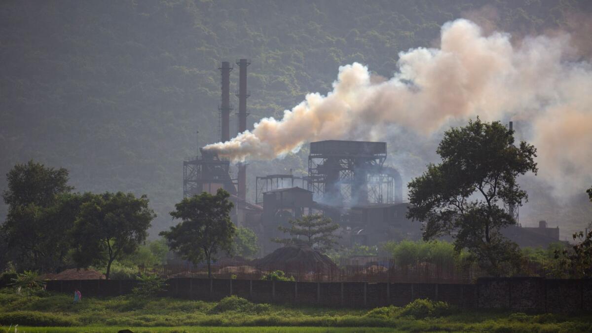 Smoke rises from a coal-powered steel plant at Hehal village near Ranchi in eastern state of Jharkhand. — AP file