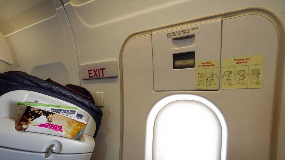 Plane passenger tries to open emergency door in mid-flight