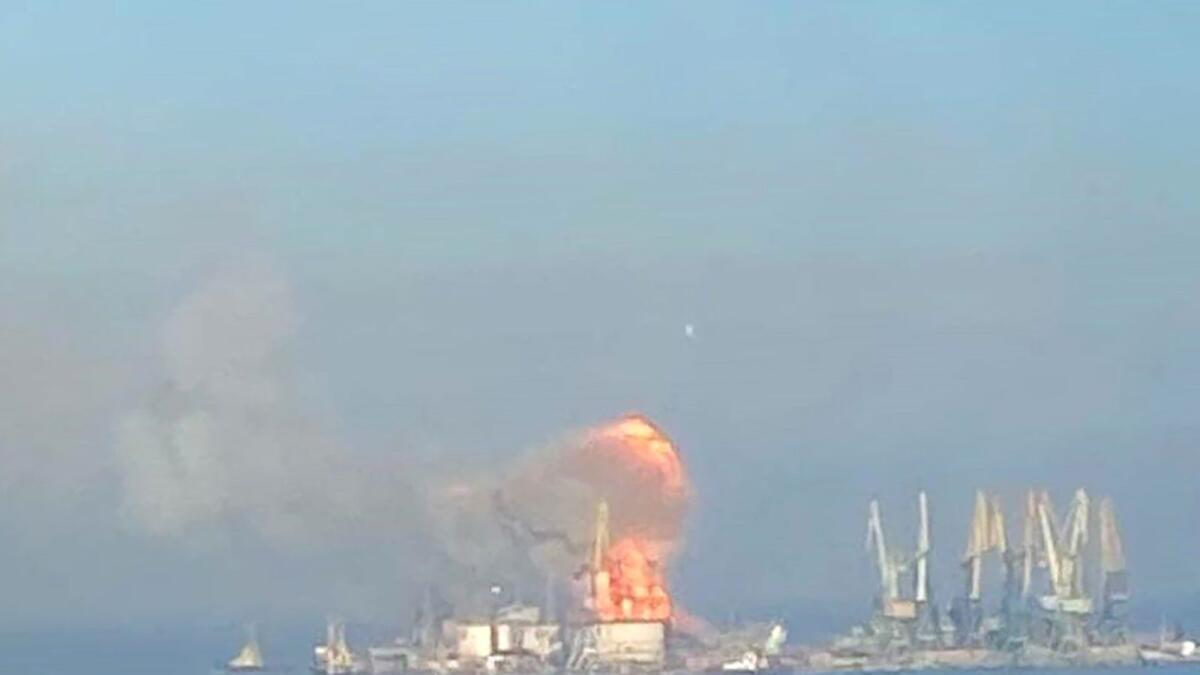 A handout picture released by the Ukrainian Navy on March 24, 2022 shows plumes of smoke and flames in the port of Berdyansk in the Azov Sea, 80 kilometres to the west of  Mariupol, on the site where reportedly the large landing ship 'Orsk' of the Russian Black Sea Fleet is docked. Photo: AFP