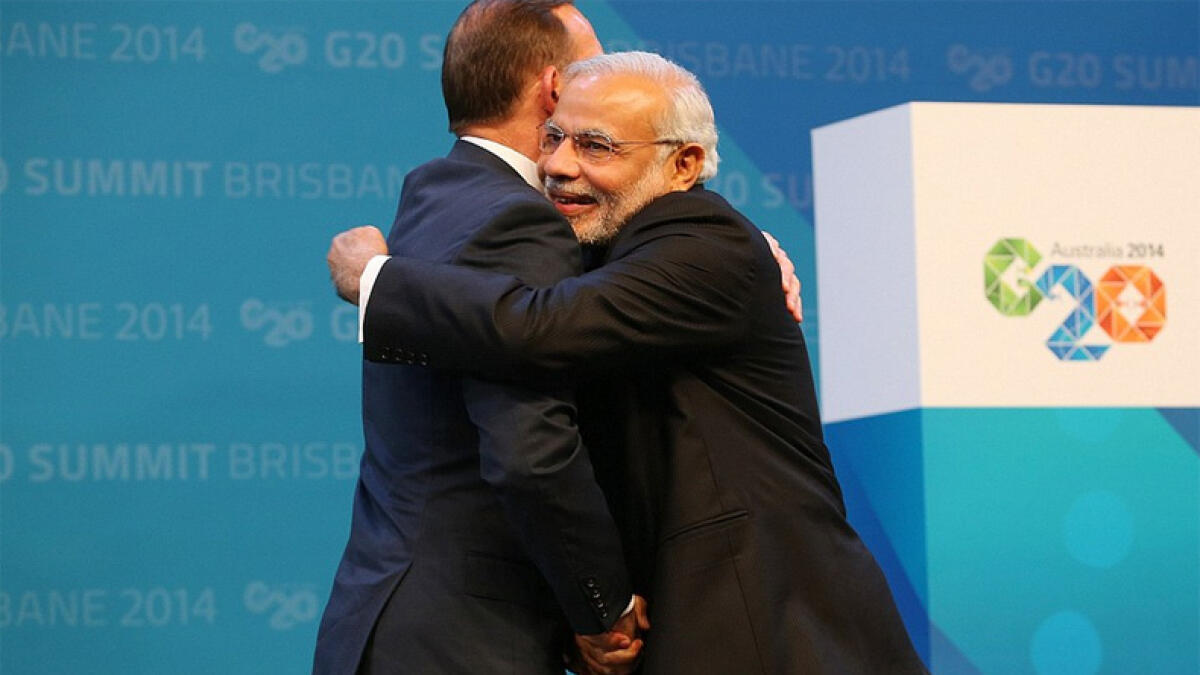 Australian Prime Minister Tony Abbott (L) embraces Prime Minister Narendra Modi as he officially welcomes leaders to the G20 summit in Brisbane.