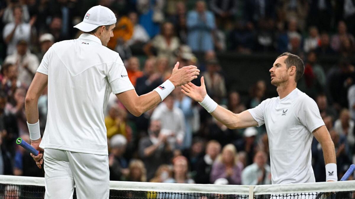 Britain's Andy Murray (right) shakes hands with John Isner of the US after their second round match at Wimbledon. (AFP)