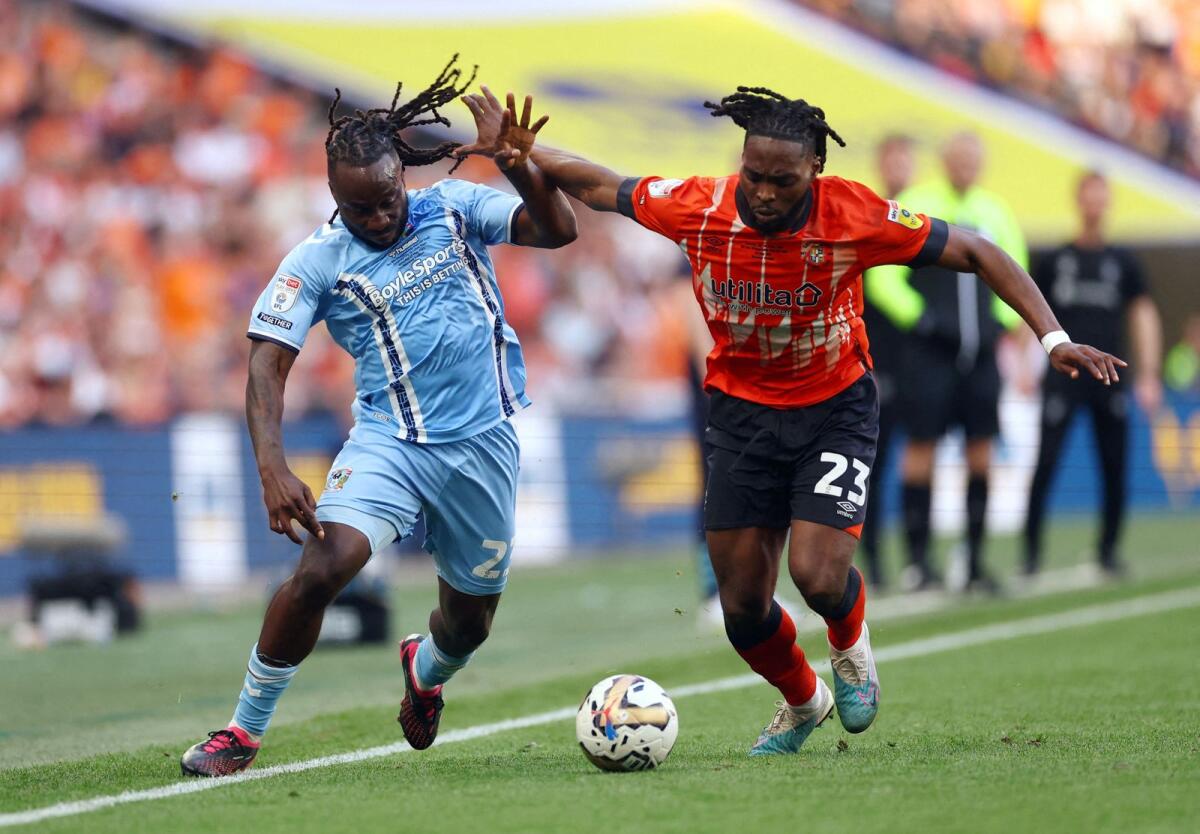 Coventry City's Fankaty Dabo  (left) in action with Luton Town's Fred Onyedinma. — Reuters