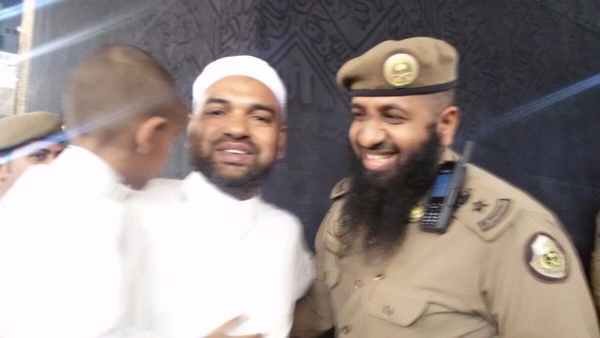 Abdul Hadhi with his son and Haram police at Kaaba