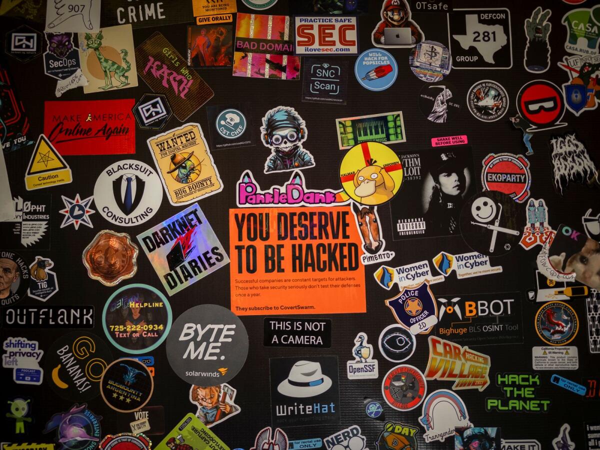 Stickers decorating a laptop at the annual Defcon hackers conference in Las Vegas, on August 12, 2023. Over three days, 2,200 people filed into an off-Strip conference room, using 156 loaner laptops to seek out the dark side of artificial intelligence. — Mikayla Whitmore/The New York Times