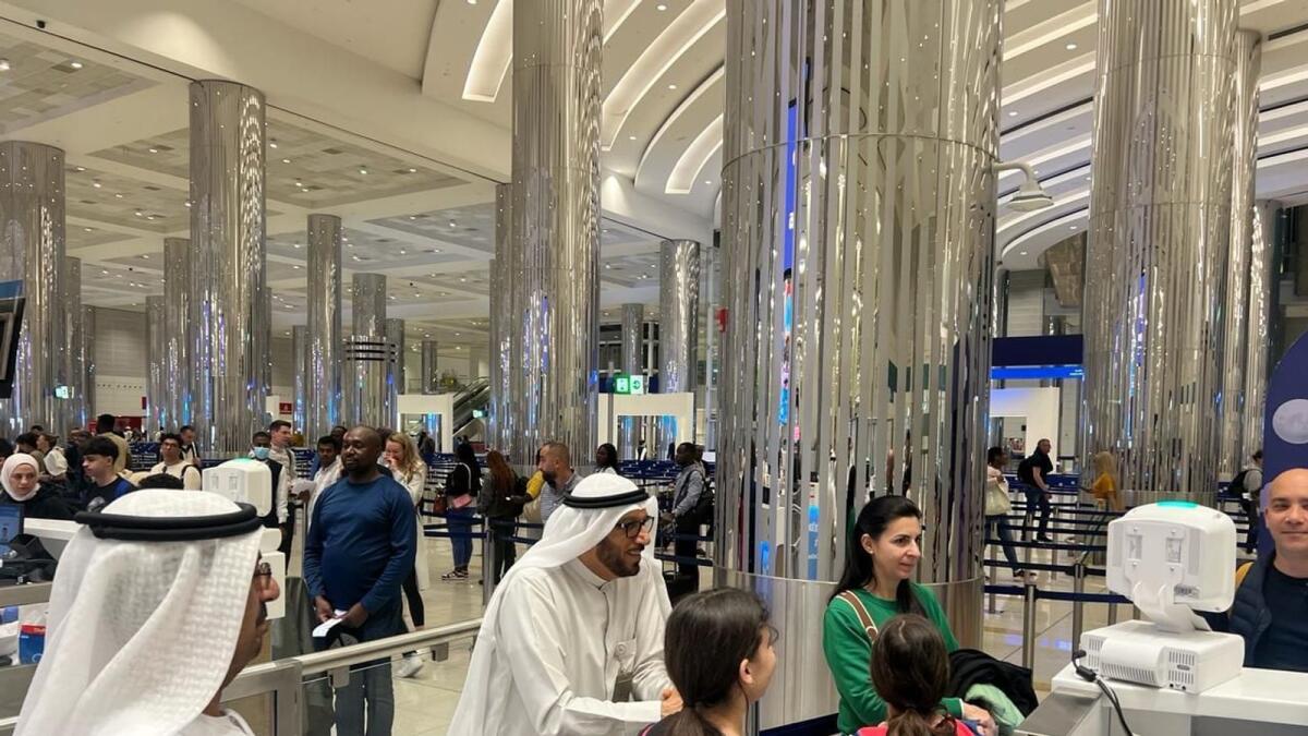 Officials assist passengers at Dubai airport. — Wam