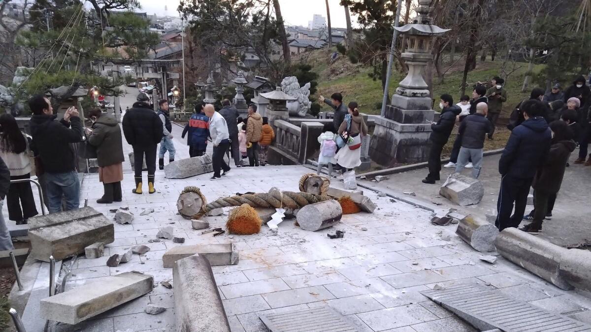 A torii gate is damaged after an earthquake at a shrine in Kanazawa. — AP