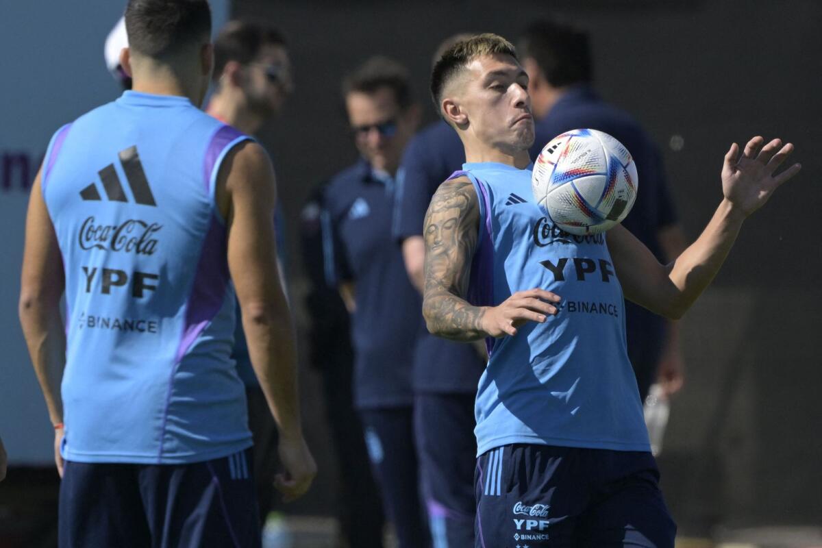 Argentina's defender Lisandro Martinez (right) controls the ball during a training session. — AFP