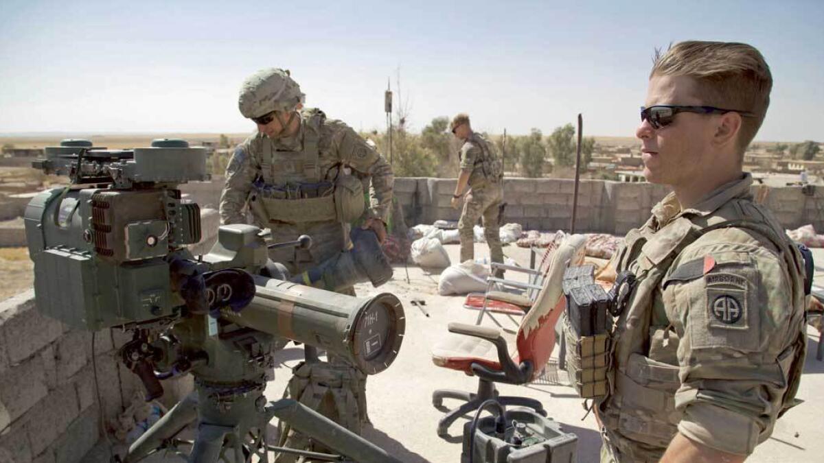 US Army soldiers stand next to a guided-missile launcher in the village of Abu Ghaddur, east of Tal Afar, Iraq. — AFP