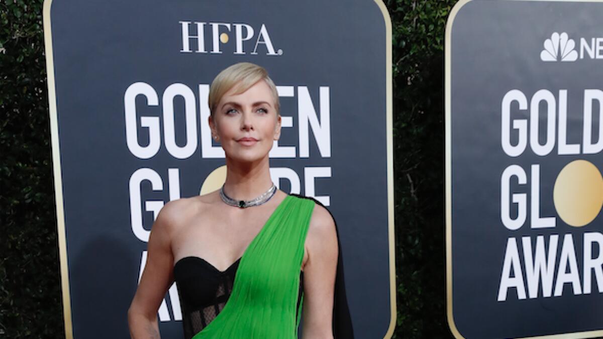Charlize Theron wows a in one-shouldered green gown