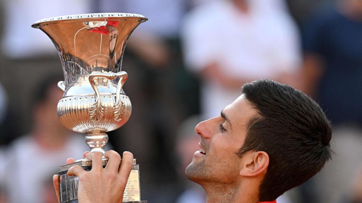 Serbia's Novak Djokovic celebrates with the trophy after winning the Italian Open final. (AFP)