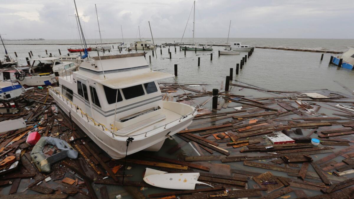 Debris floats around damaged boats in a marina after it was hit by Hurricane Hanna, on Sunday, July 26, 2020, in Corpus Christi, Texas. About 30 boats were lost or damaged in the storm at the marina. Photo: AP
