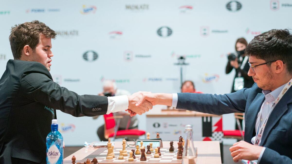 Iranian-born French chess GM, Alireza Firouzja (right) and Magnus Carlsen. — FIDE