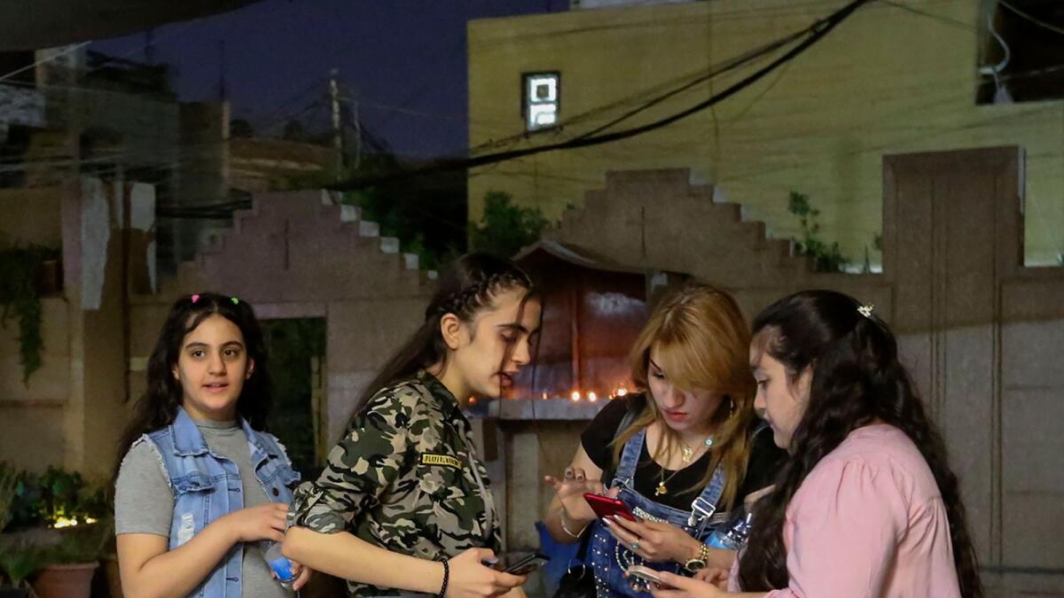 Youths chat in the yard after mass at the Chaldean Church of St. Joseph in the Iraqi capital Baghdad.