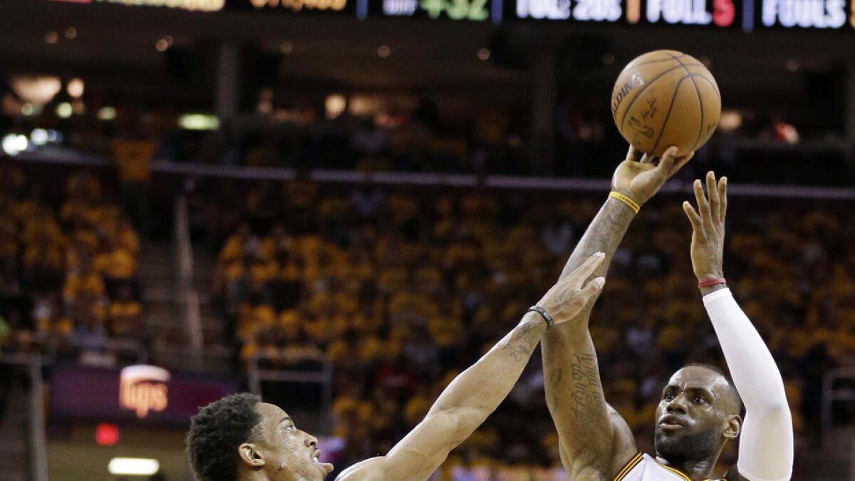 Cleveland Cavaliers' LeBron James (23) shoots over Toronto Raptors' DeMar DeRozan (10) during the second half of Game 5 of the NBA basketball Eastern Conference finals Wednesday, May 25, 2016, in Cleveland. (AP Photo/Tony Dejak)