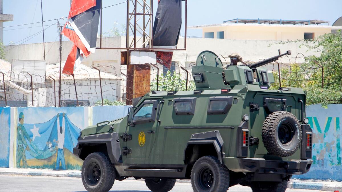 Somalia security officers patrol near the SYL hotel building which was attacked on Thursday. — Photo: AP