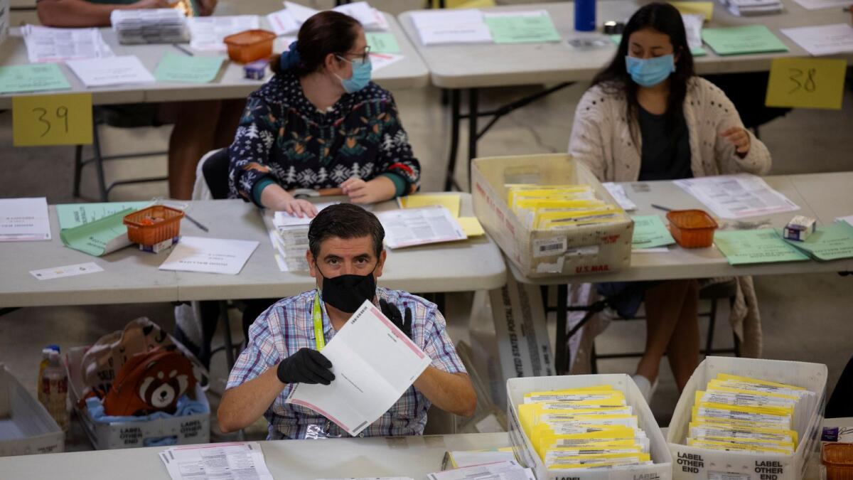 Election workers sort through the thousands of mail-in ballots at the Orange County Registrar of Voters in Santa Ana, California, U.S., November 2, 2020.