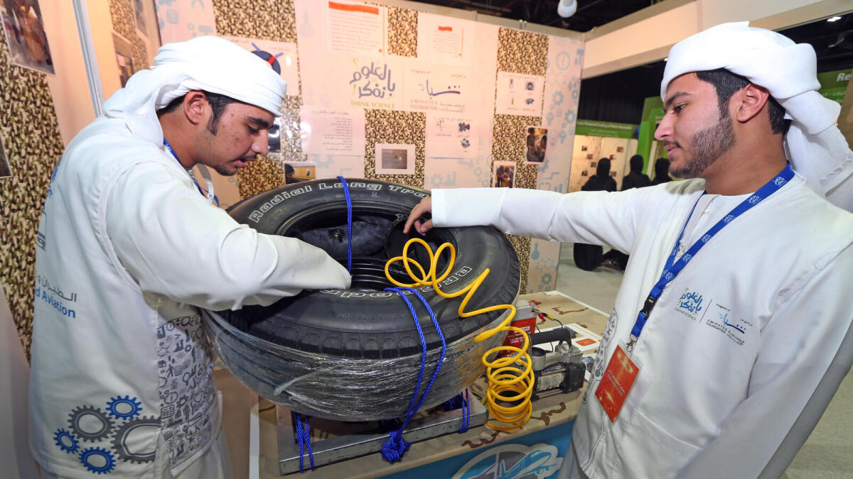 Shuaib Al Zarouni and Saif Al Marzooqui show their bullet resistant tyre for the military, and Rauda Al Shamsi explains the working of the eco-friendly car wash at  the Think Science Fair 2016 going on at the Dubai World Trade Centre.  — Photos by Dhes Handumon