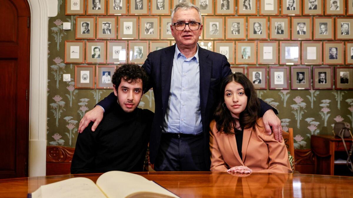 The husband and children of this year's winner of the Nobel Peace Prize, Ali, Taghi and Kiana Rahmani pose for pictures after signing the guest book  at the Nobel Institute in Oslo, Norway, December 9, 2023. Reuters