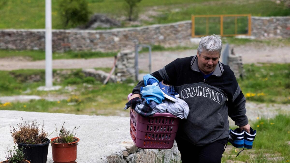 Gjystina Grisha, a 'Burrnesha' (sworn virgin), collects laundry at her home in the mountain village of Lepushe, 200 km from Tirana, on May 25, 2023.