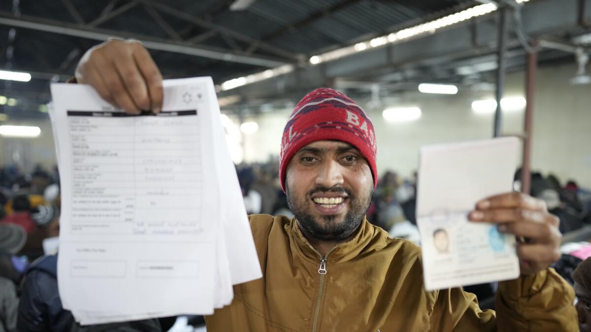 Anup Singh, an Indian skilled worker aspiring to be hired for a job in Israel shows his passport and a form he filled during a recruitment drive in Lucknow. — AP