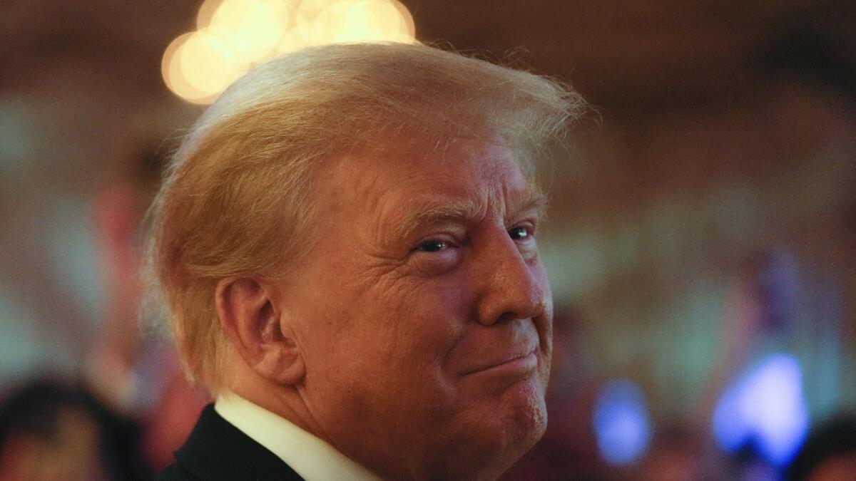 Former president Donald Trump smiles toward guests as he arrives to speak at an event at Mar-a-Lago on Nov. 18, 2022 in Palm Beach, Florida. — AP