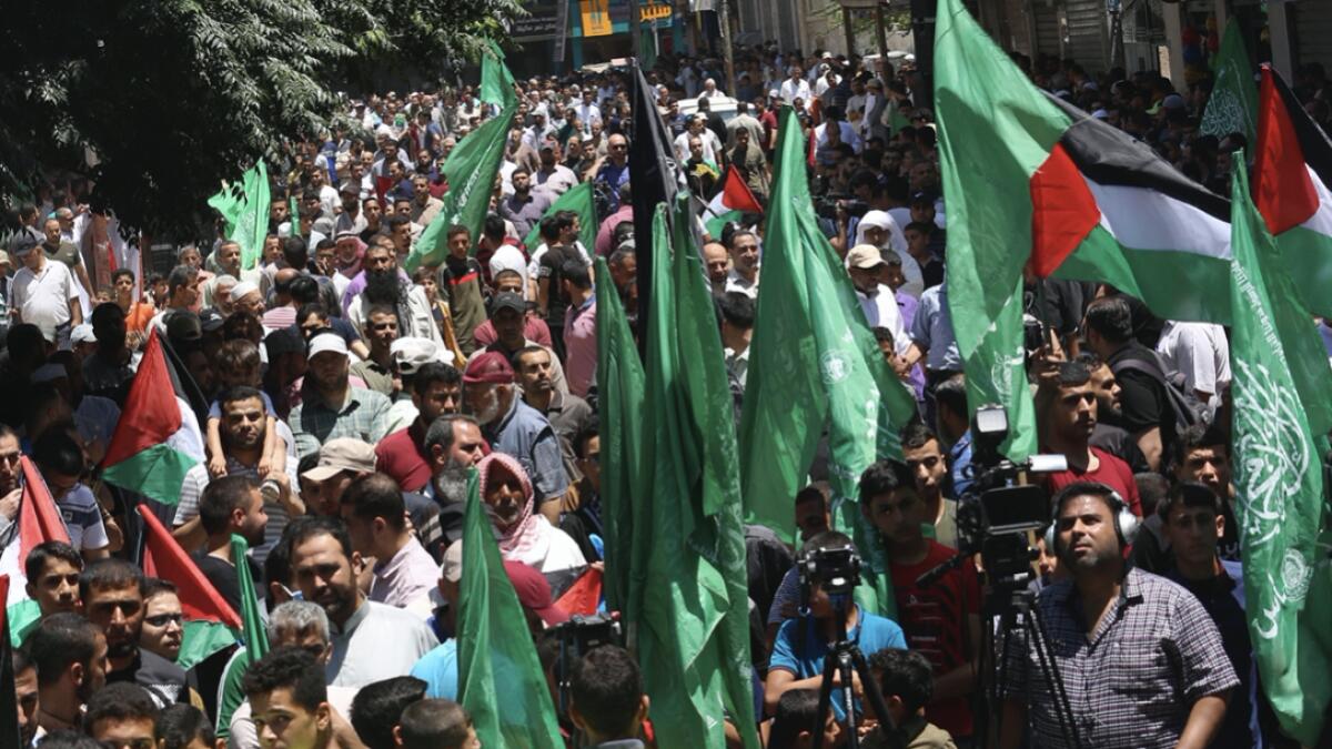 Hamas supporters wave their green and national flags during a protest against Israel's plan to annex parts of the West Bank and US President Donald Trump's mideast initiative, after Friday prayer at the main road of Khan Younis City, Gaza Strip. Photo: AP