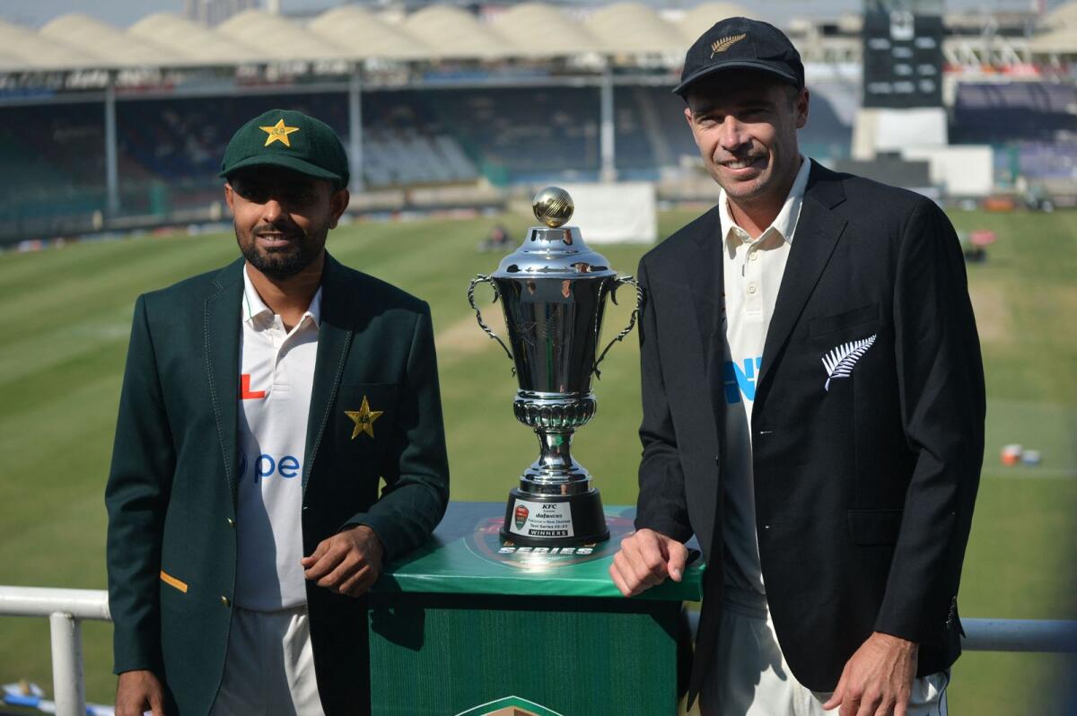 New Zealand captain Tim Southee (right) and his Pakistani counterpart Babar Azam unveil the Test series trophy at the National Stadium in Karachi. — AFP