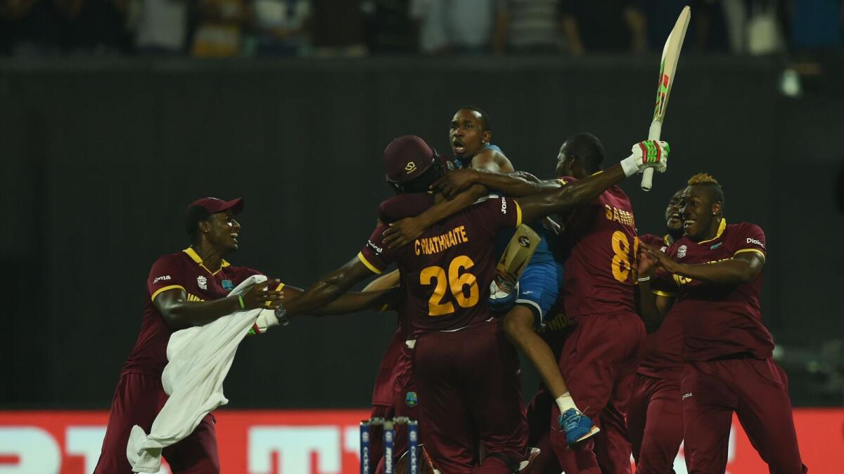 West Indies players celebrate after victory in the World T20 cricket tournament final match between England and West Indies at The Eden Gardens Cricket Stadium in Kolkata on April 3, 2016.