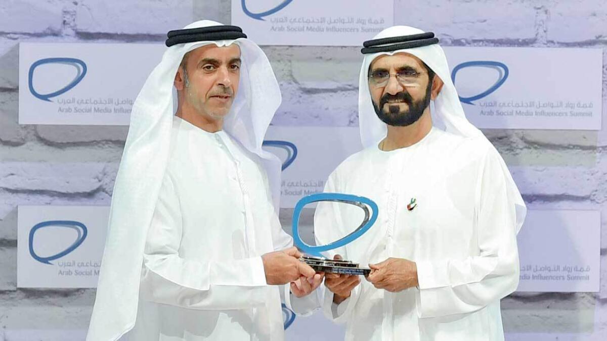 Shaikh Mohammed presenting the influencers award for the government sector to Lt-Gen Shaikh Saif bin Zayed Al Nahyan. —Wam