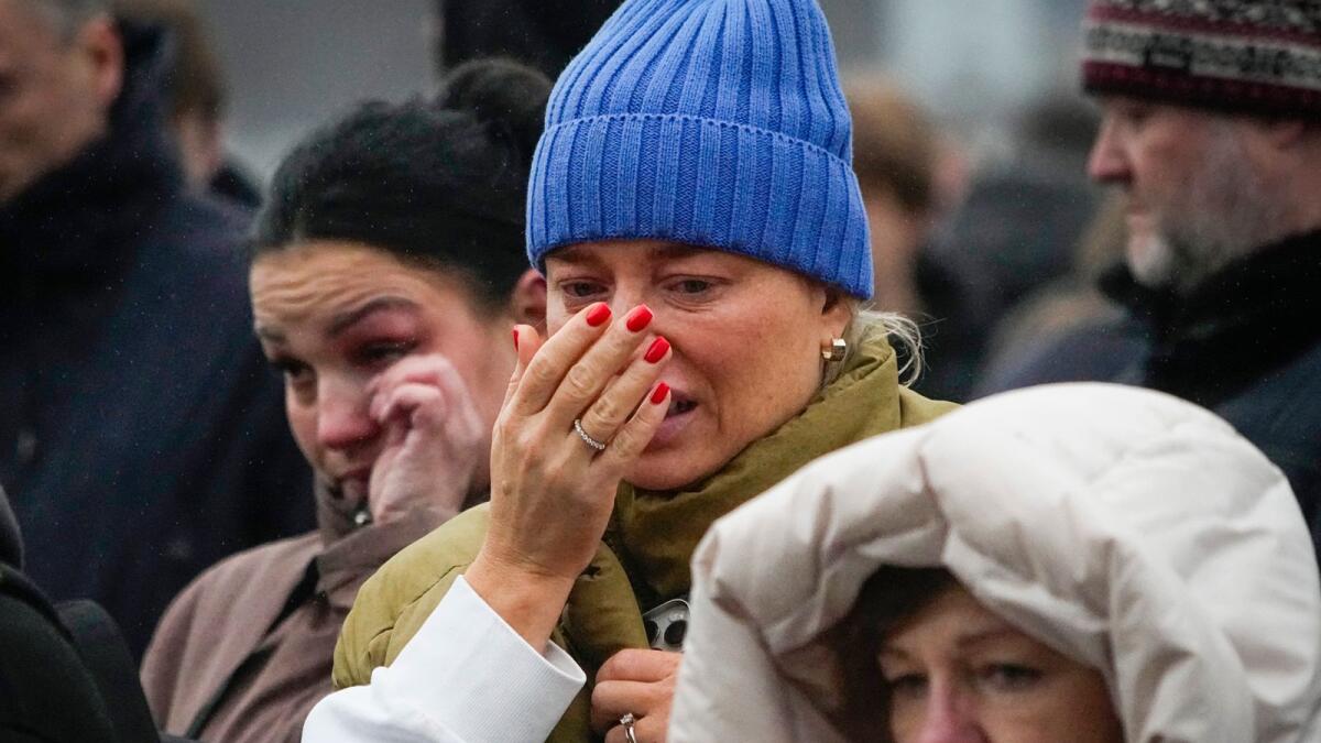 People react next to the Crocus City Hall, on the western edge of Moscow. — AP