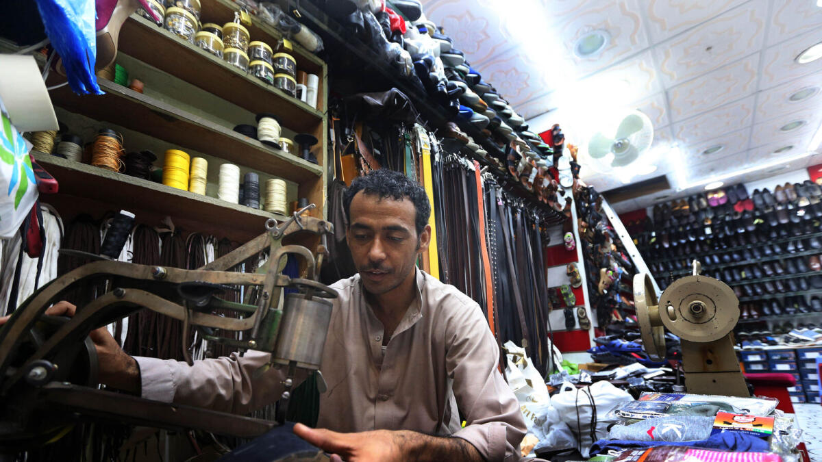 BLUE SUEDE SHOES... Footwear that comes in different colours and sizes can be fixed by shoemaker Mohammed Din at his shop.