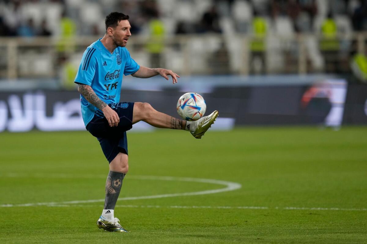 Argentina's Lionel Messi controls the ball during a training session in Abu Dhabi. — AP