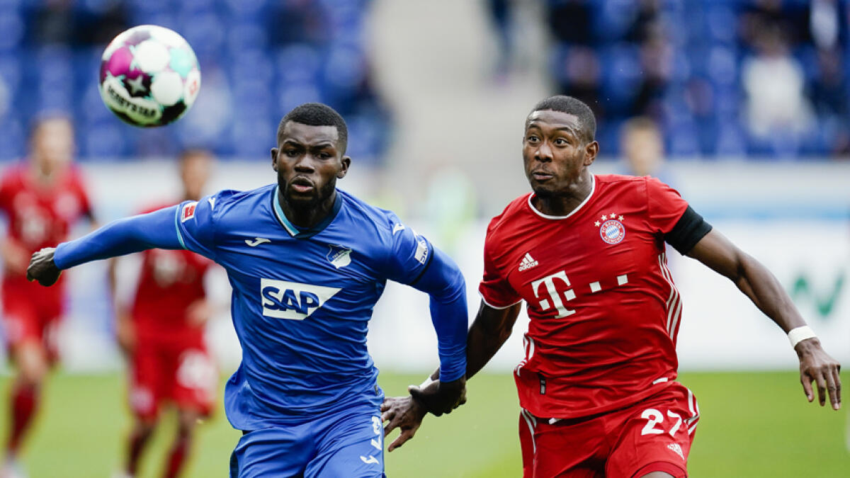 Hoffenheim's Ihlas Bebou (left) and Munich's David Alaba challenge for the ball during their Bundesliga match on Sunday. - AP