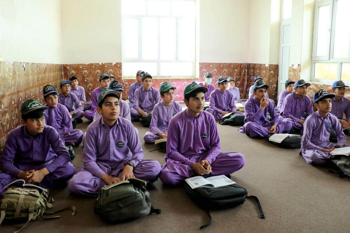 Afghan school boys attend their first class following the start of the new academic year, at a private school in Khost on Wednesday. — AFP