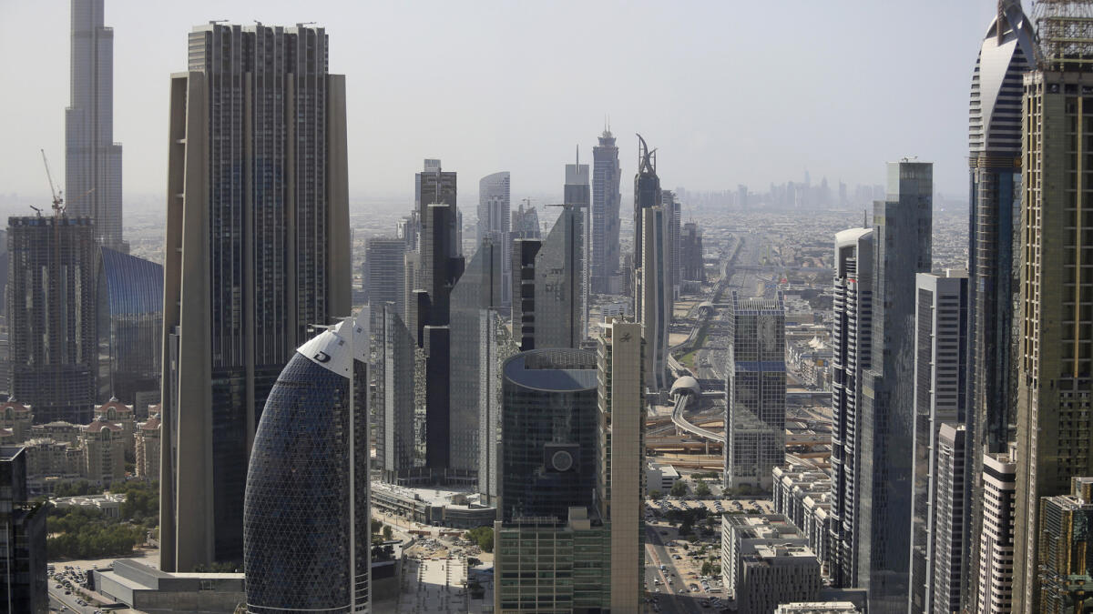 Business and residential skyscrapers stand in the financial district of the city in Dubai, United Arab Emirates, on Thursday, Nov. 6, 2014. A year ago, Dubai regulators took steps to cool a market where home values had been climbing at the fastest pace in the world. Photographer: Chris Ratcliffe/Bloomberg
