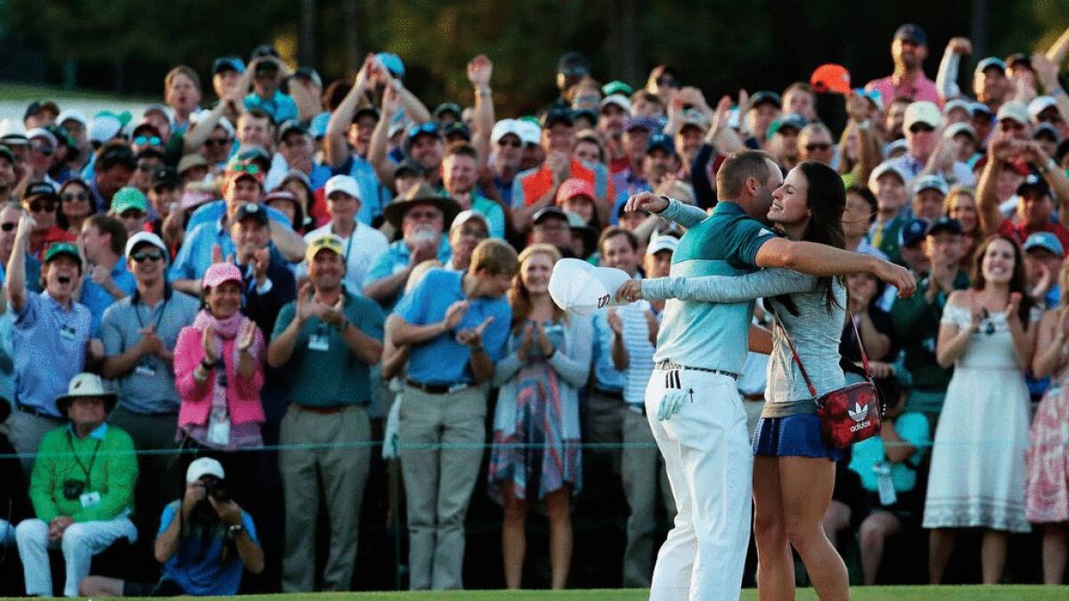 Sergio Garcia of Spain embraces fiancee Angela Akins in celebration after defeating Justin Rose (not pictured) of England on the first playoff hole during the final round of the 2017 Masters Tournament at Augusta National Golf Club on Sunday.