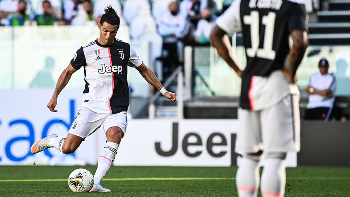 Juventus' forward Cristiano Ronaldo shoots to score a free kick during the Italian Serie A match against Torino on Saturday. -- AFP