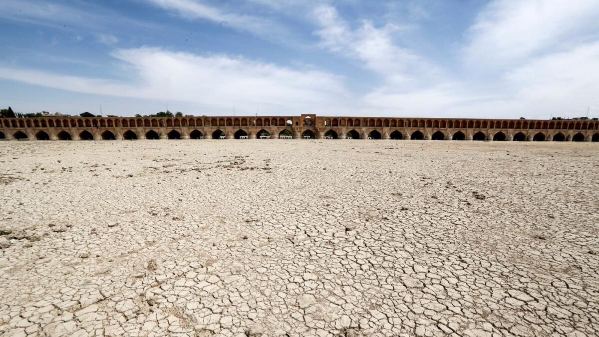 Dried up riverbed of the Zayandeh Roud river that no longer runs under the 400-year-old Si-o-seh Pol bridge in Isfahan, Iran. Photo: AFP