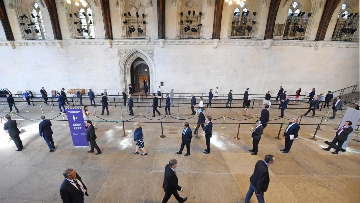 British, lawmakers, queues, Palace of Westminster, cast, votes, coronavirus-induced, measures