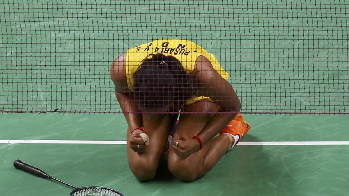 P.V. Sindhu slumps on her knees with a roar after her  shocking quarterfinal win over World no.2 Wang Yihan of China.