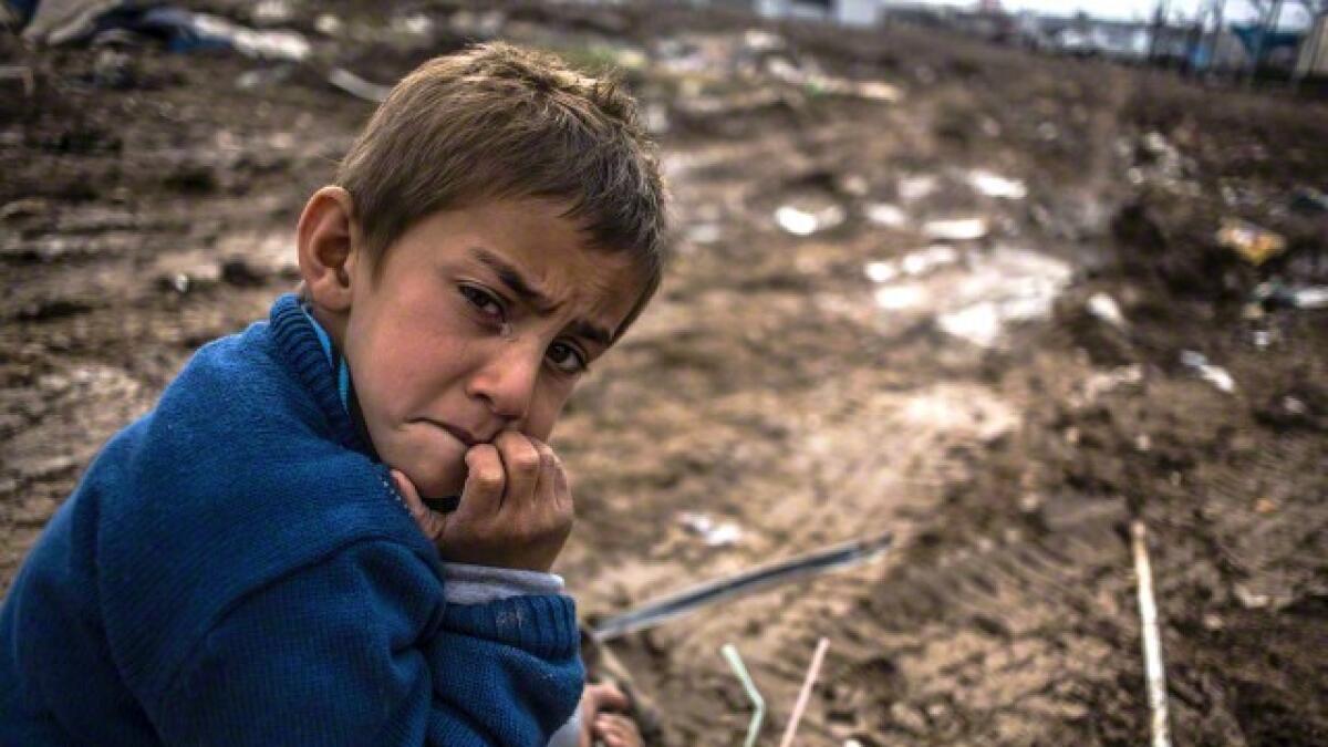 A tear forms in the eye of a young boy in the Domiz refugee camp in northern Iraq