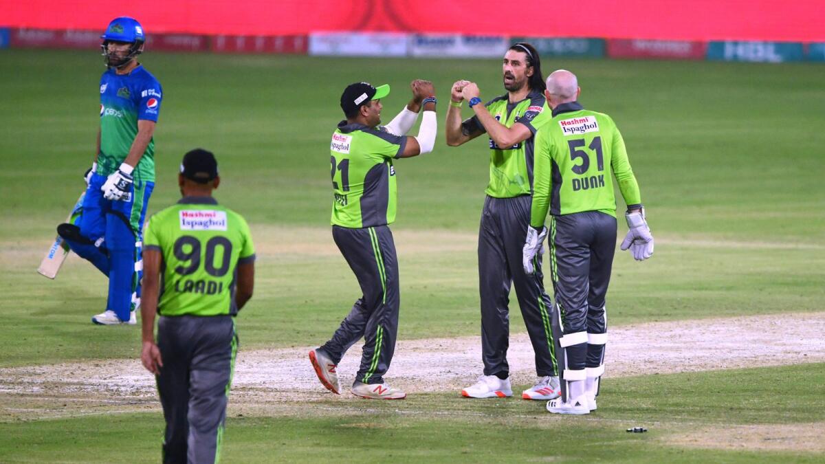 Lahore Qalandars' David Wiese (second right) celebrates with teammates after bowling out to Multan Sultans' Sohail Tanveer (unseen). — AFP