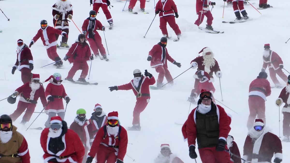 Some of the 300 skiers registered for the annual charity ski run descend the slopes at the Sunday River Ski Resort.